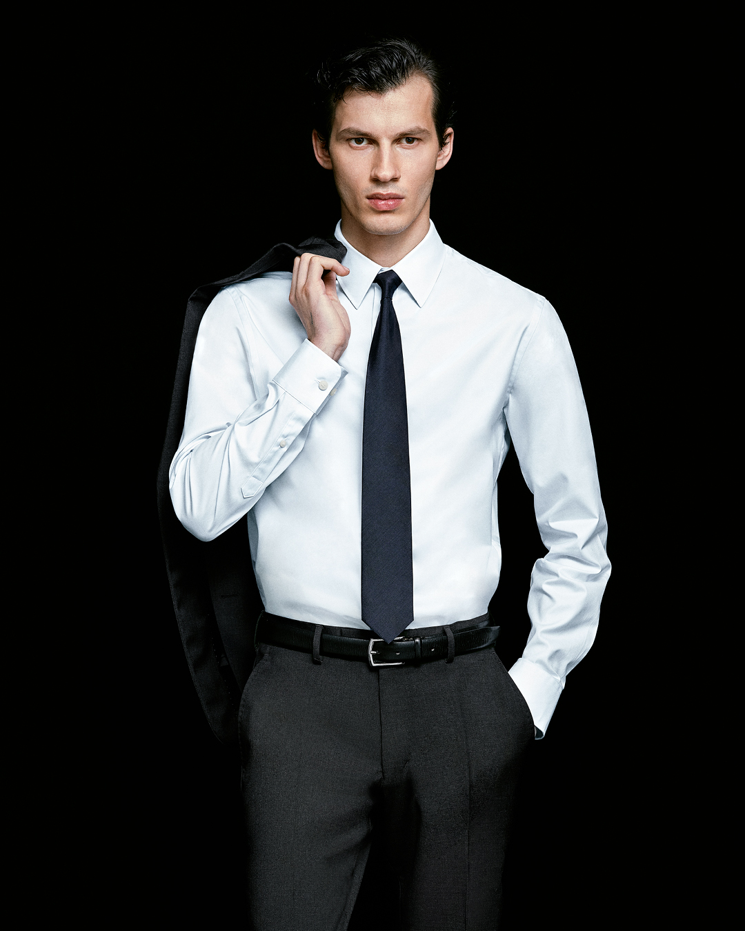 man in suit and white adley shirt